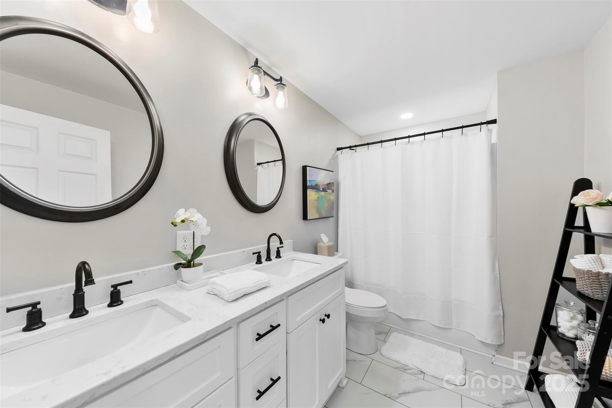 411 South Battleground Avenue Kings Mountain, NC 28086 - Photo 22 of 38 a bathroom with a double vanity sink and a mirror