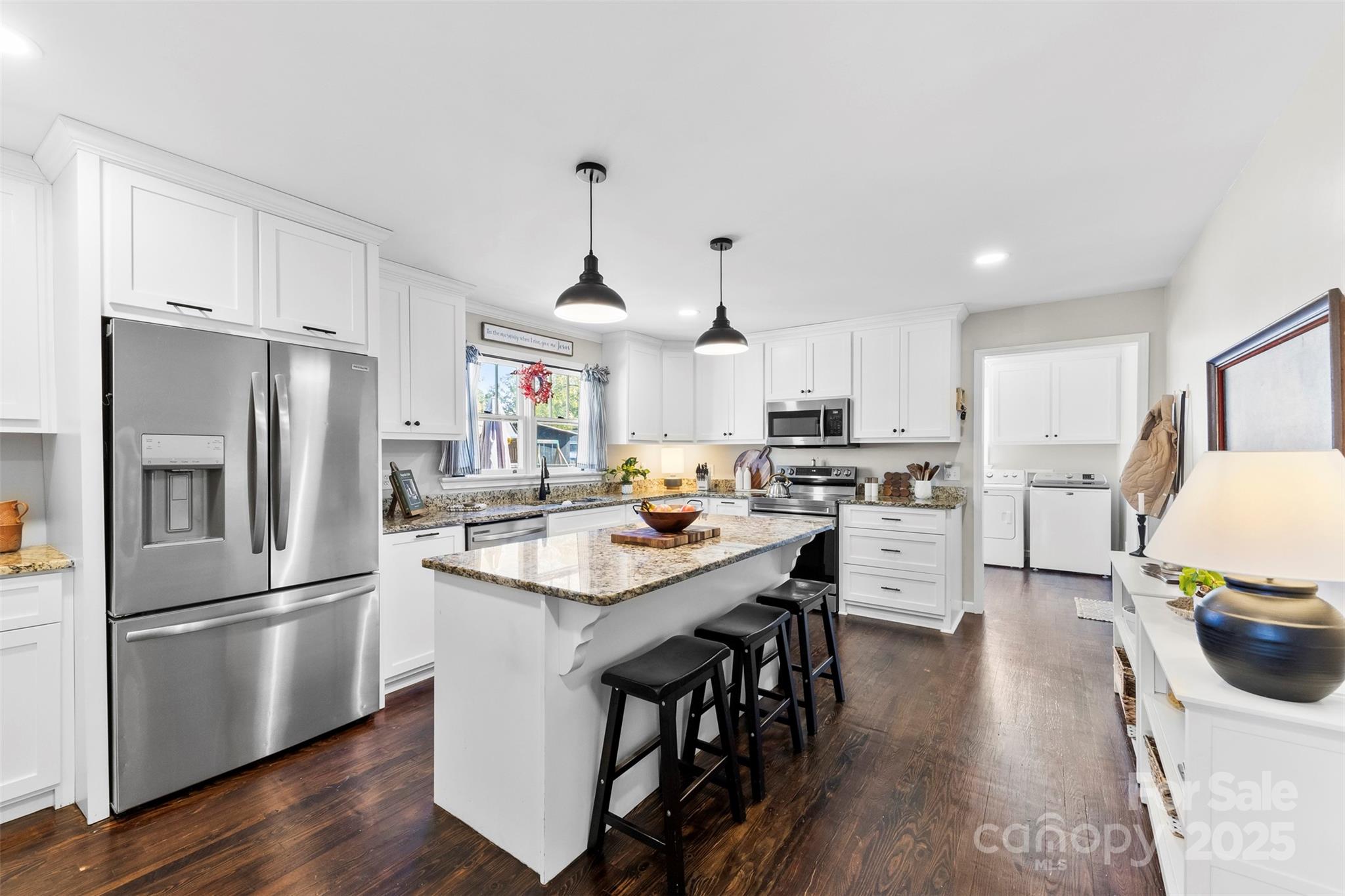 411 South Battleground Avenue Kings Mountain, NC 28086 - Photo 5 of 38 a kitchen with stainless steel appliances granite countertop a refrigerator a sink dishwasher a stove and a refrigerator with wooden floor
