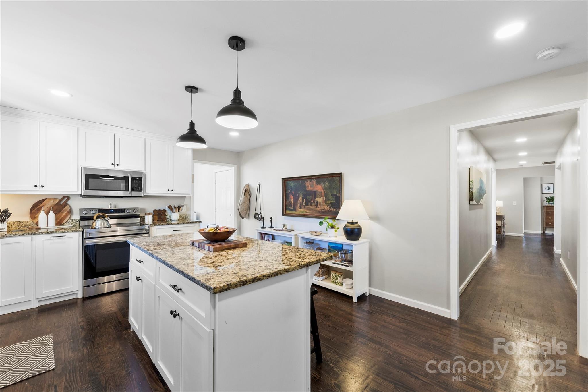 411 South Battleground Avenue Kings Mountain, NC 28086 - Photo 6 of 38 a kitchen with granite countertop a sink cabinets a counter and stainless steel appliances