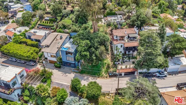 an aerial view of multiple houses with yard