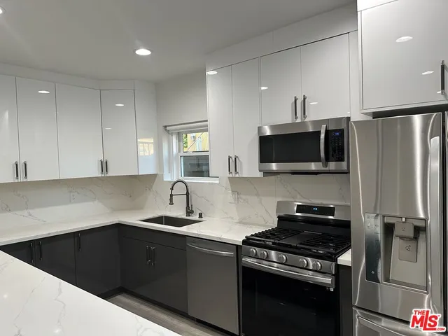 a kitchen with a sink stove and microwave