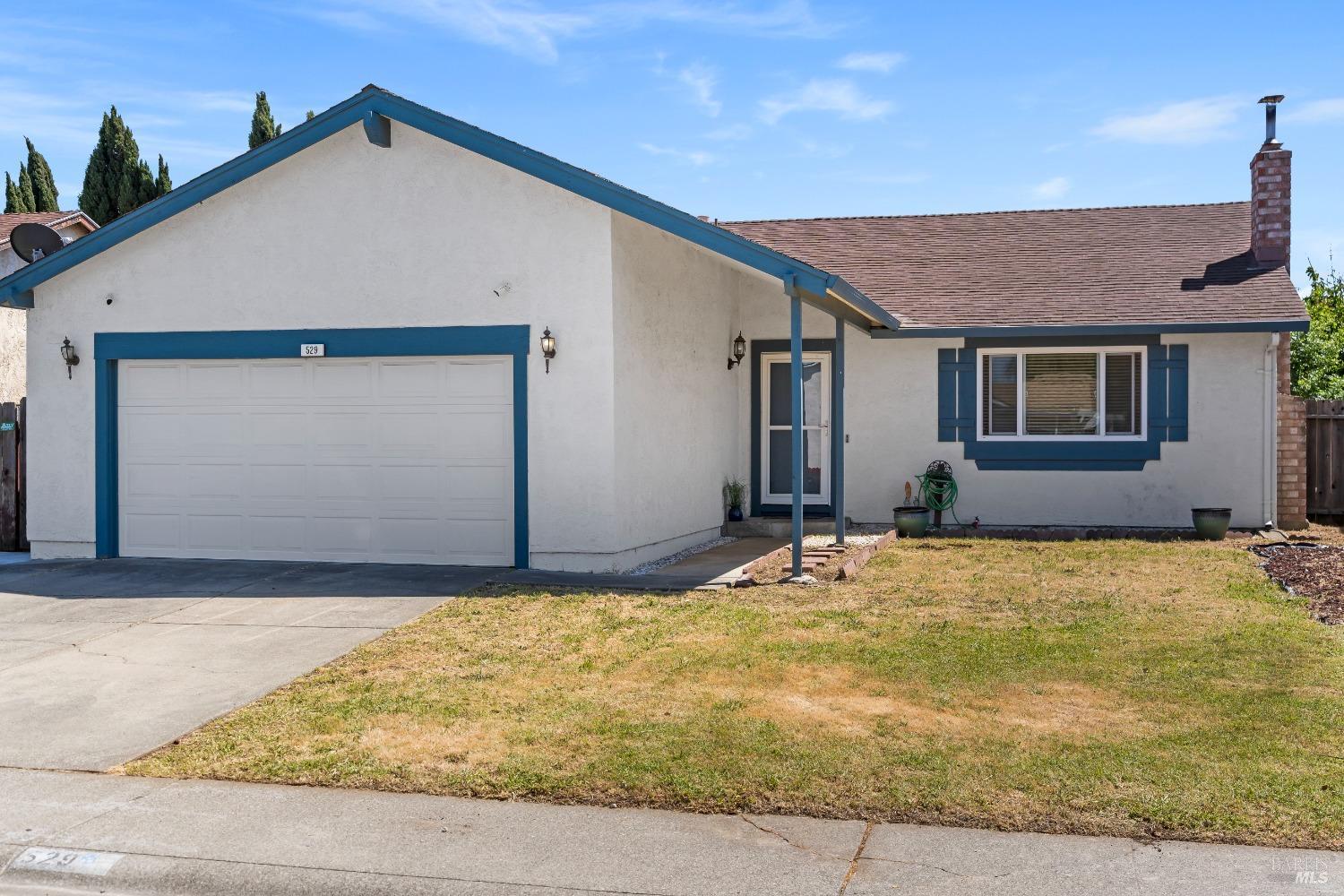 a house with yard next to a road