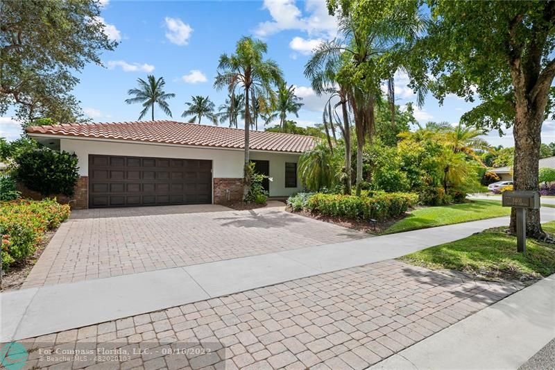 a front view of a house with a yard and a garage