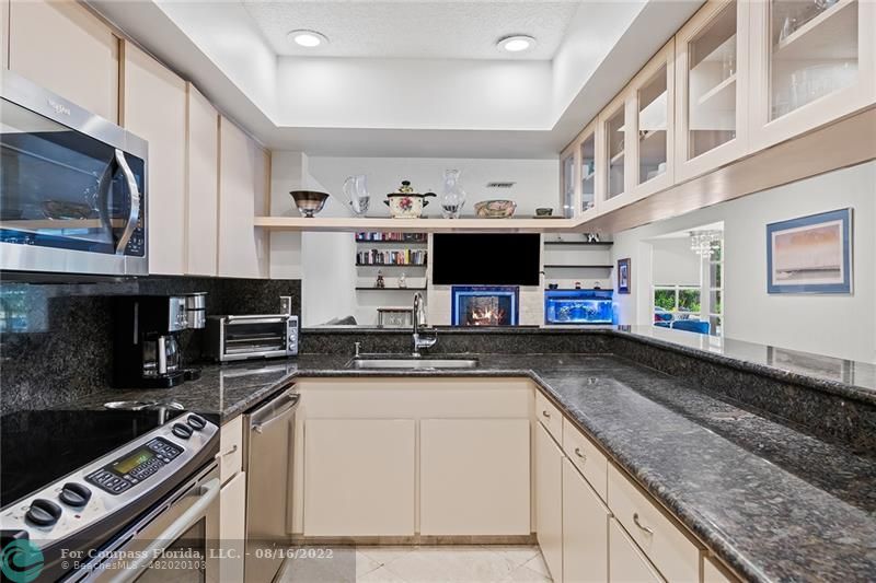 3401 North 31st Terrace Hollywood, FL 33021 - Photo 15 of 35 a kitchen with stainless steel appliances granite countertop a stove and a sink