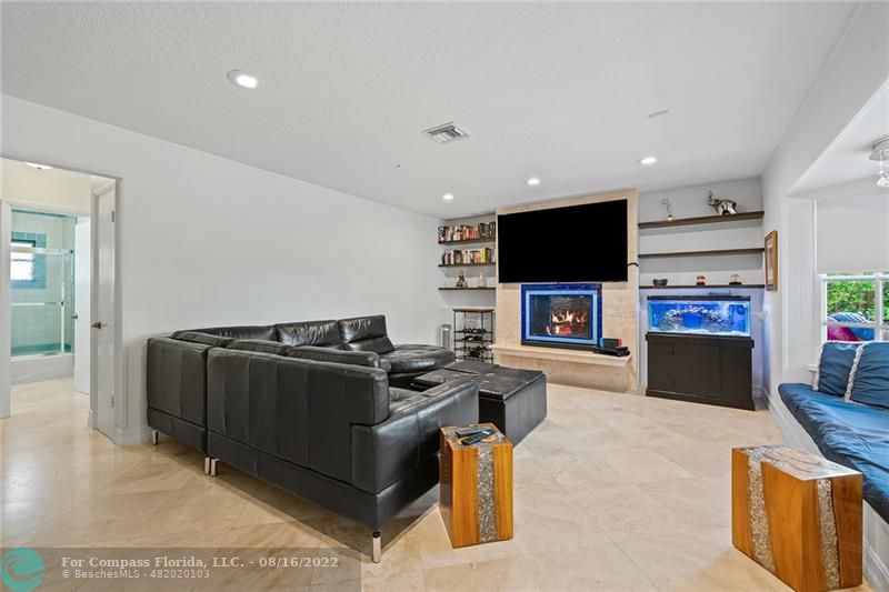 3401 North 31st Terrace Hollywood, FL 33021 - Photo 19 of 35 a living room with furniture a flat screen tv and a fireplace