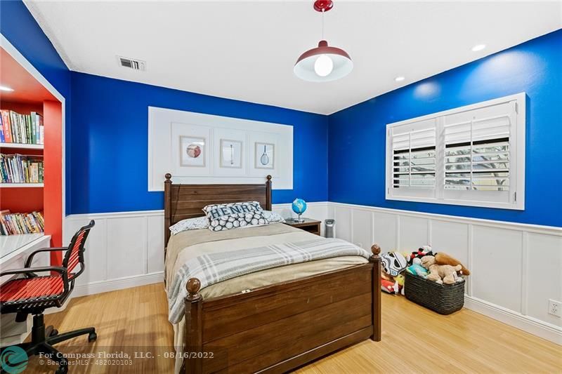 3401 North 31st Terrace Hollywood, FL 33021 - Photo 31 of 35 a bedroom with a bed and a chandelier