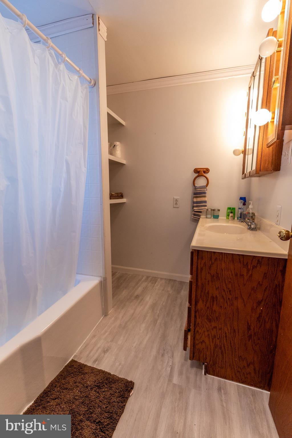 60 Policeman Club Road Falling Waters, WV 25419 - Photo 11 of 32 Full bath features updated flooring + linen shelf