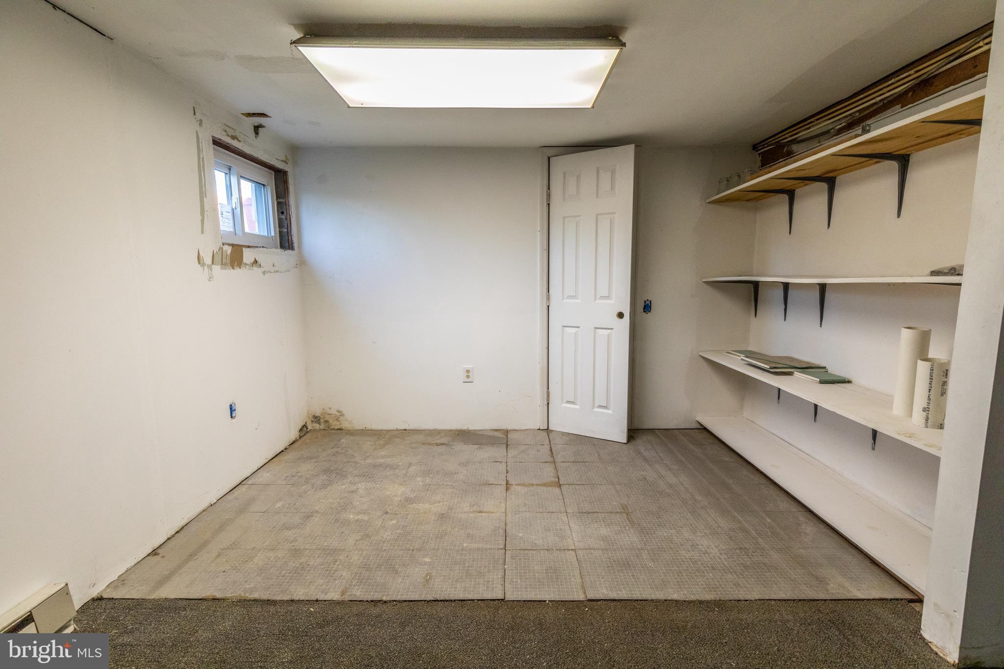 60 Policeman Club Road Falling Waters, WV 25419 - Photo 26 of 32 Small workshop area with great shelving storage