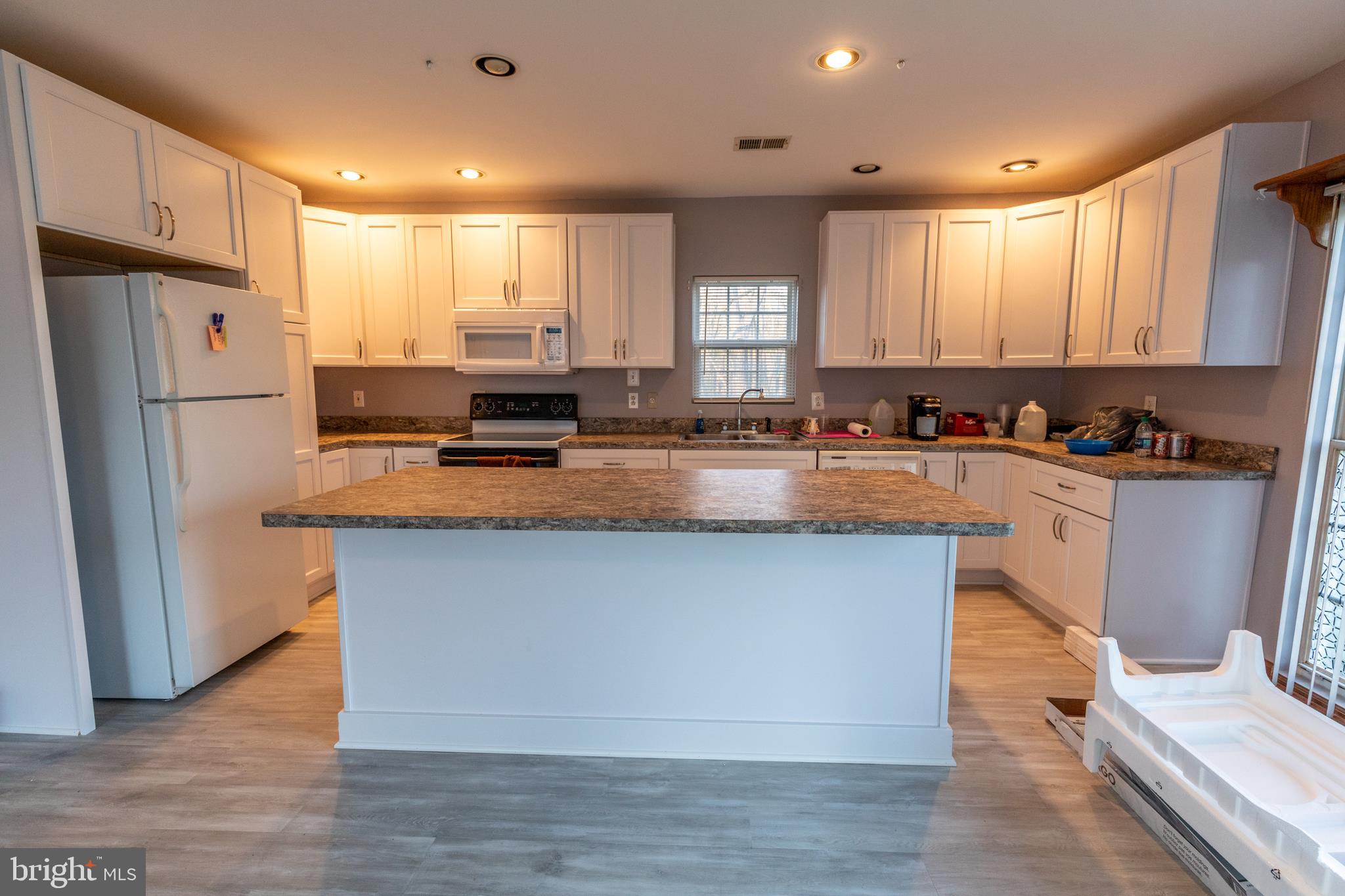 60 Policeman Club Road Falling Waters, WV 25419 - Photo 7 of 32 Huge island in kitchen defines the different space