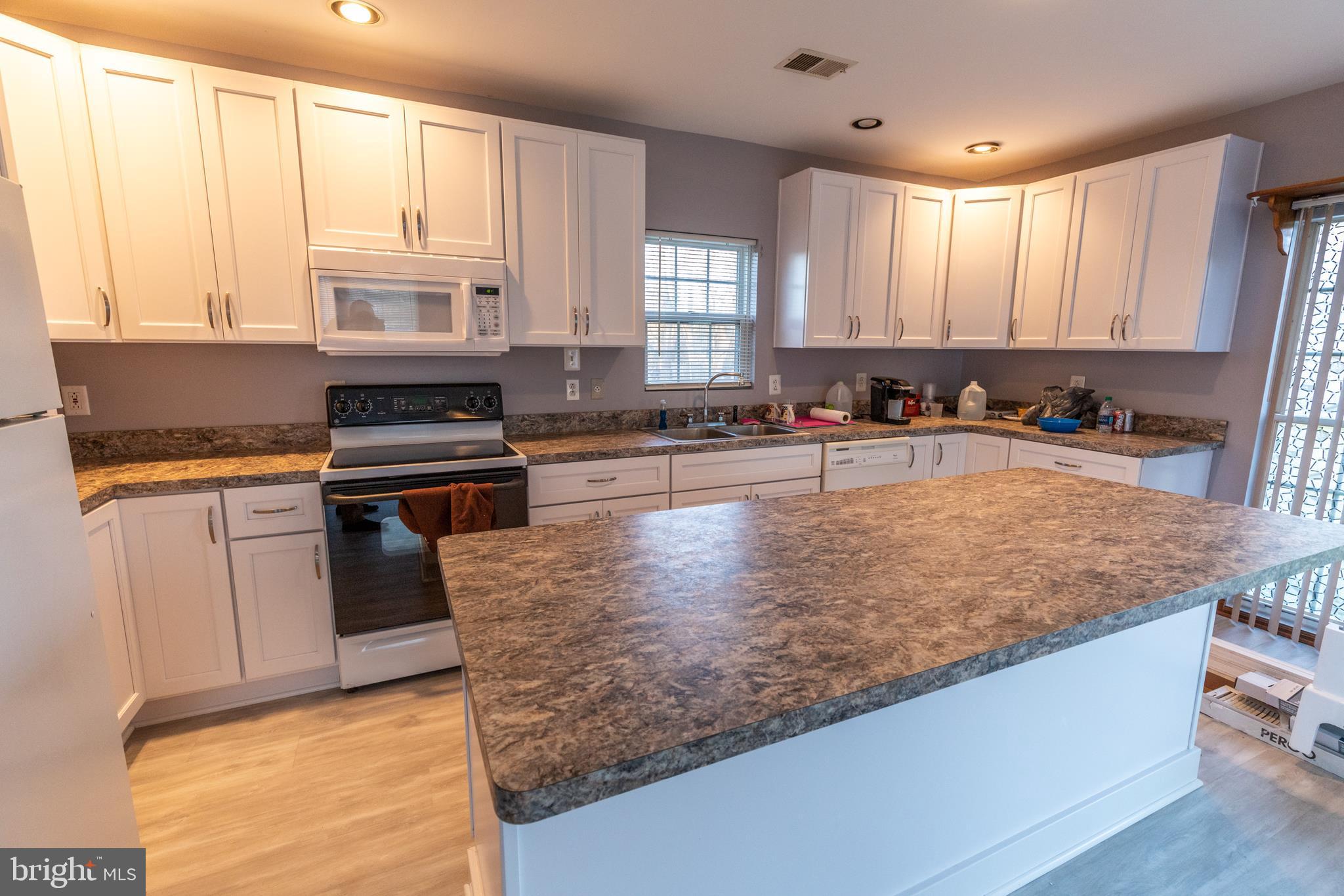 60 Policeman Club Road Falling Waters, WV 25419 - Photo 9 of 32 Features painted white cabinets and recessed light
