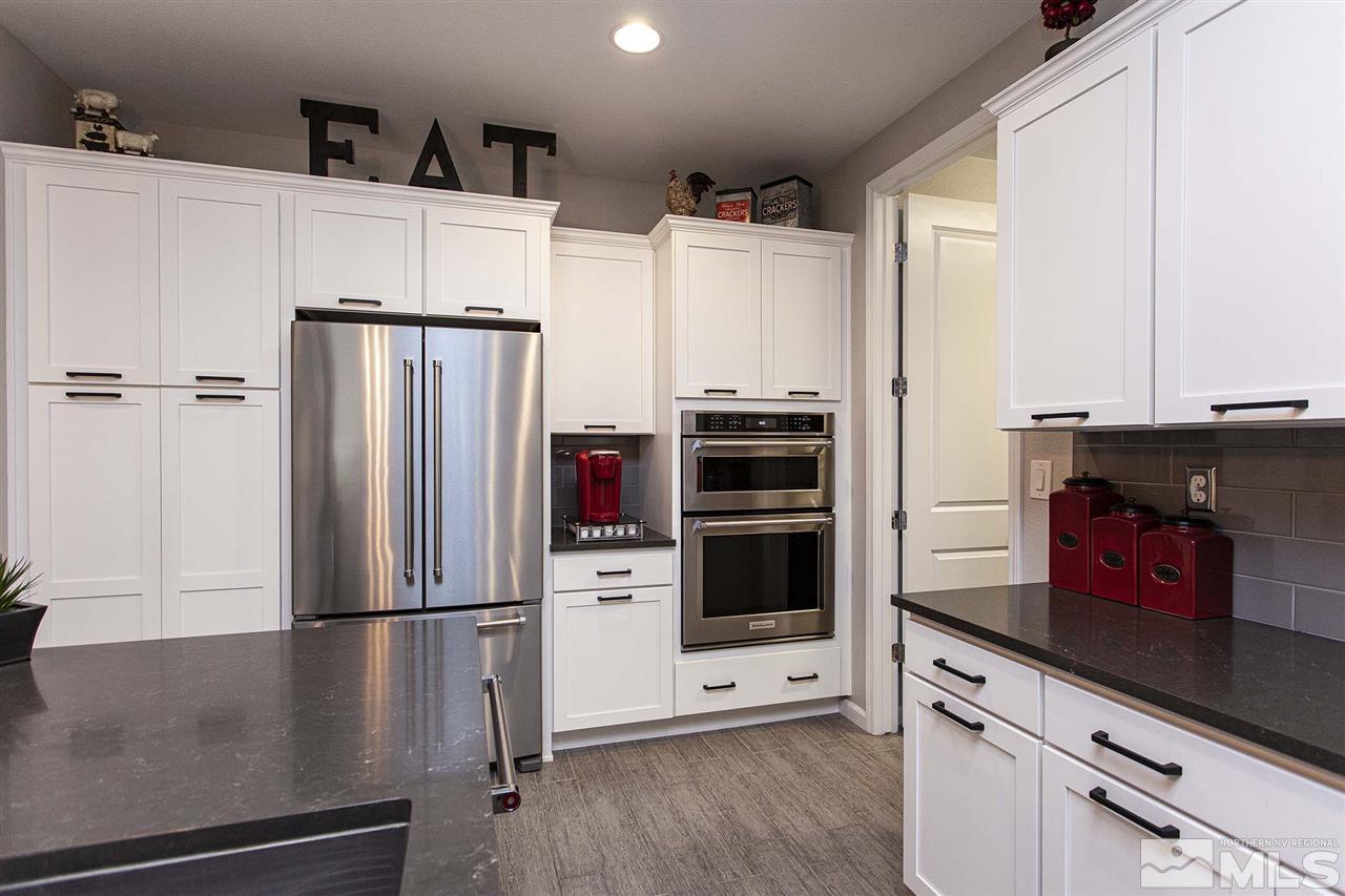 2190 Arpagos Lane Reno, NV 89521 - Photo 12 of 38 a kitchen with stainless steel appliances a refrigerator stove and sink