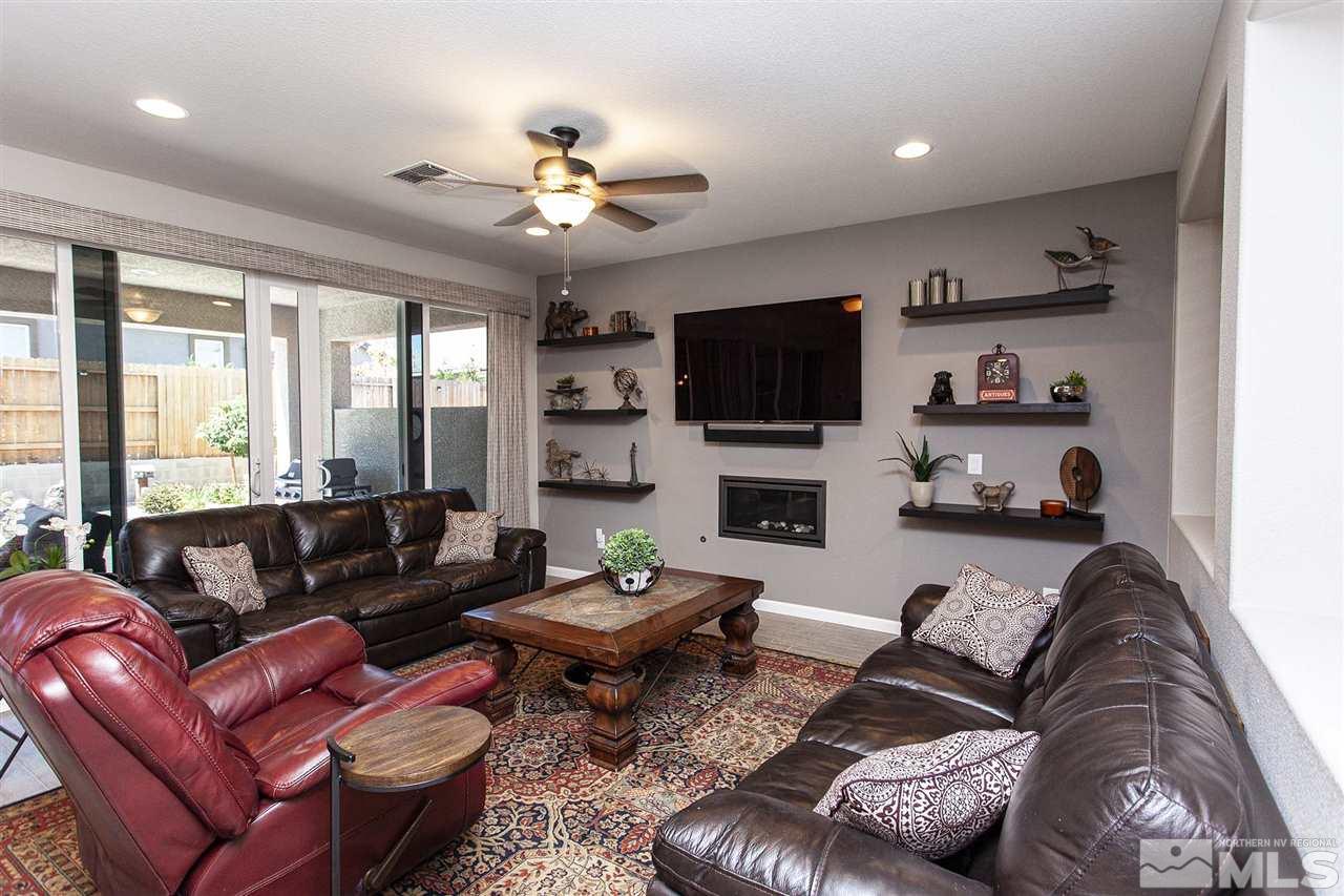 2190 Arpagos Lane Reno, NV 89521 - Photo 16 of 38 a living room with furniture a flat screen tv and a large window