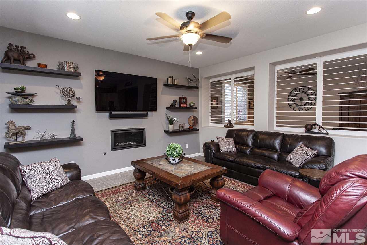 2190 Arpagos Lane Reno, NV 89521 - Photo 17 of 38 a living room with furniture a flat screen tv and a window