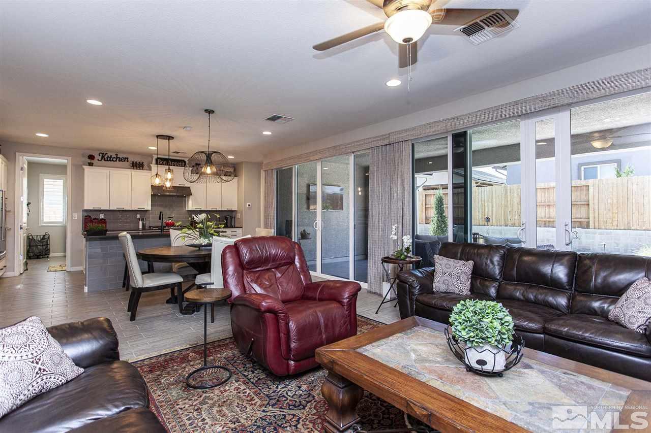 2190 Arpagos Lane Reno, NV 89521 - Photo 18 of 38 a living room with furniture and a chandelier