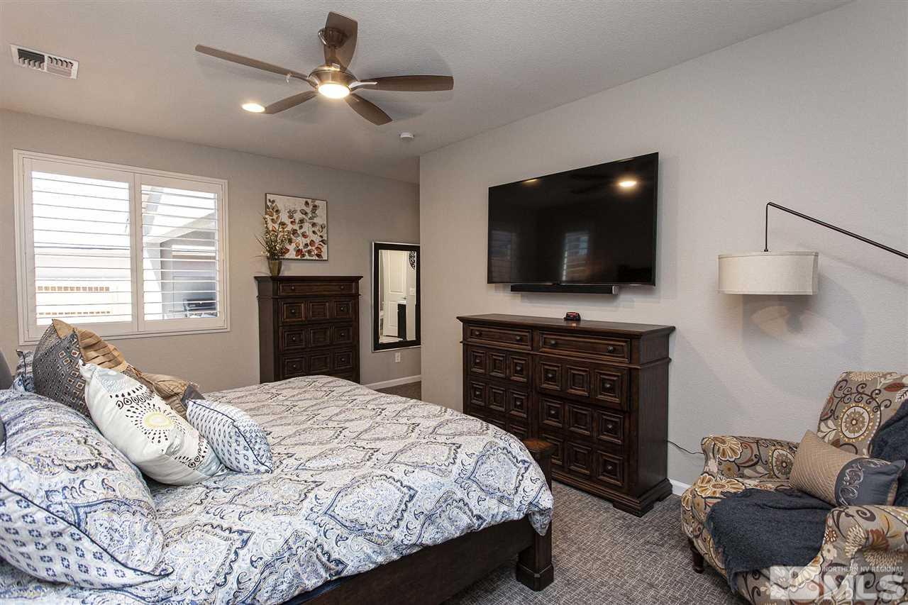 2190 Arpagos Lane Reno, NV 89521 - Photo 21 of 38 a bedroom with a bed and a flat screen tv