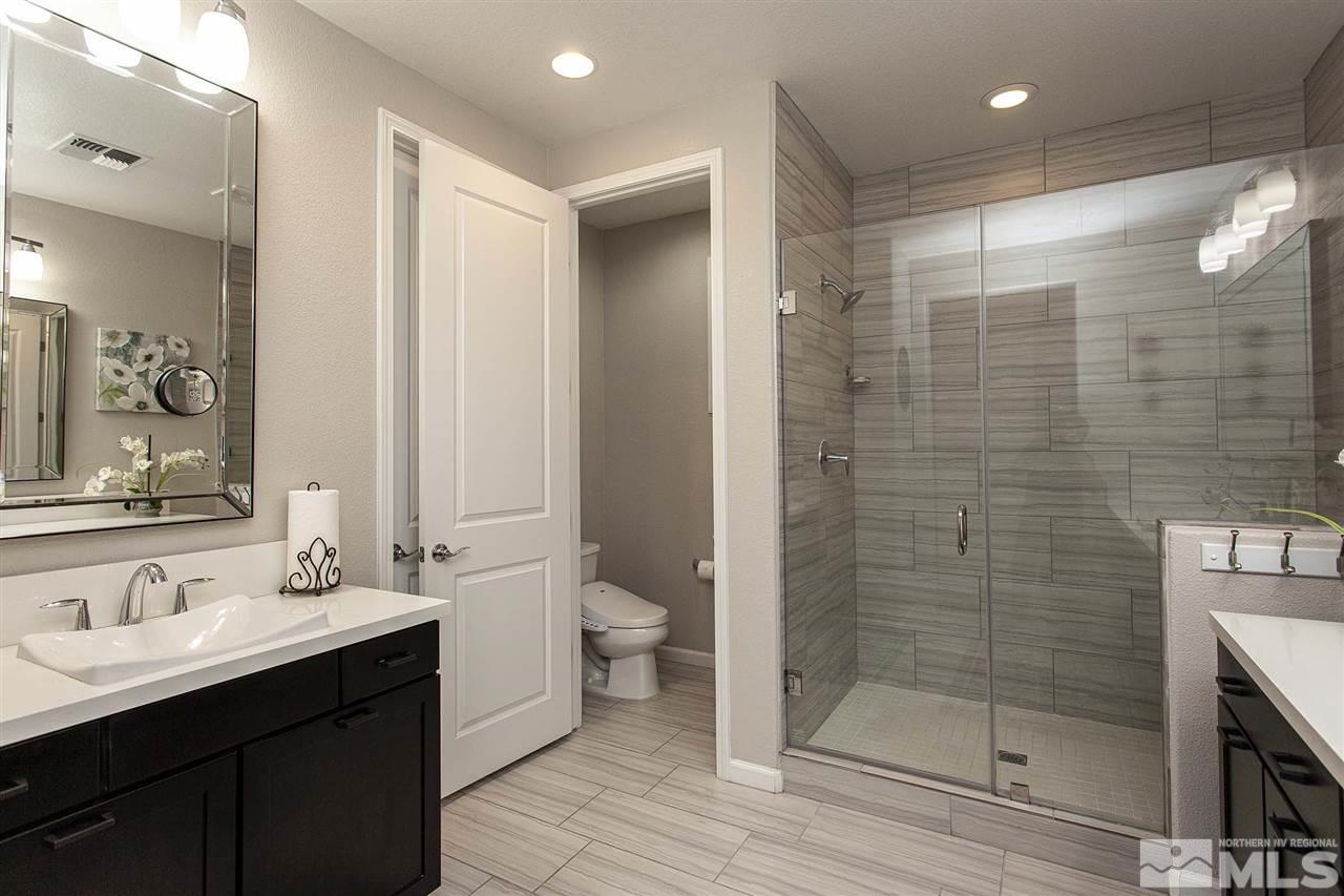2190 Arpagos Lane Reno, NV 89521 - Photo 22 of 38 a bathroom with a double vanity sink mirror and shower