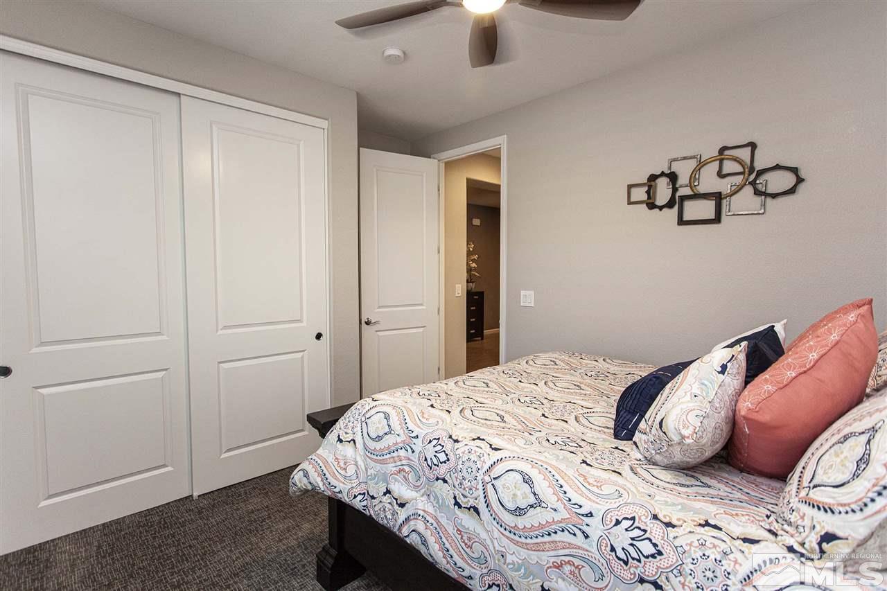 2190 Arpagos Lane Reno, NV 89521 - Photo 24 of 38 a bedroom with a bed and a chandelier