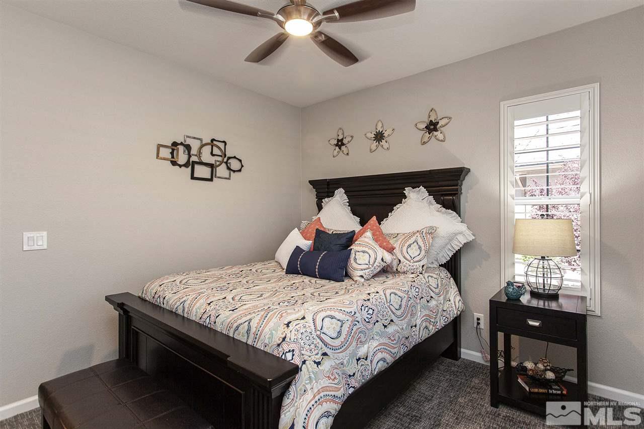 2190 Arpagos Lane Reno, NV 89521 - Photo 26 of 38 a bedroom with a bed and wooden floor