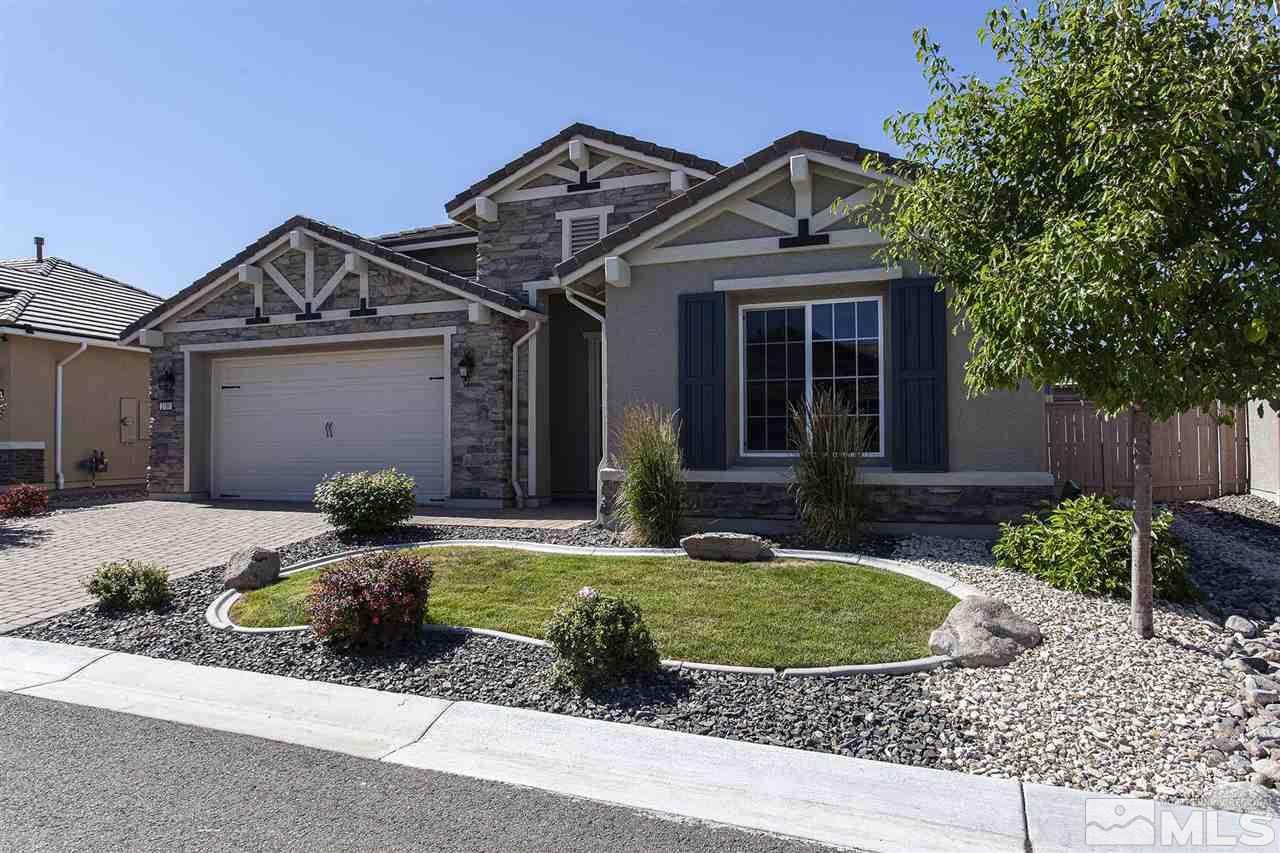 2190 Arpagos Lane Reno, NV 89521 - Photo 3 of 38 a front view of a house with a yard and garage