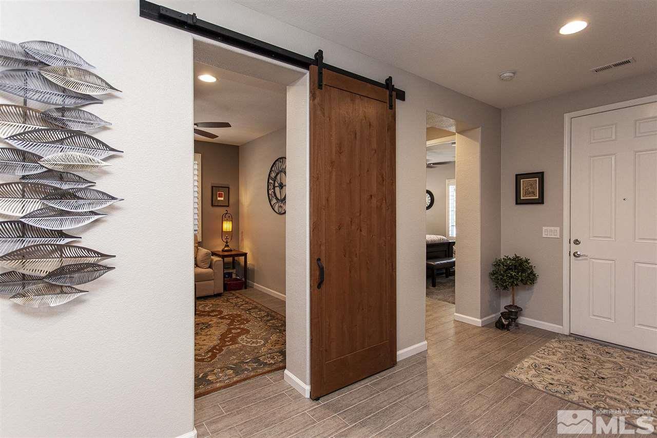 2190 Arpagos Lane Reno, NV 89521 - Photo 5 of 38 a view of a hallway with bathroom and wooden floor
