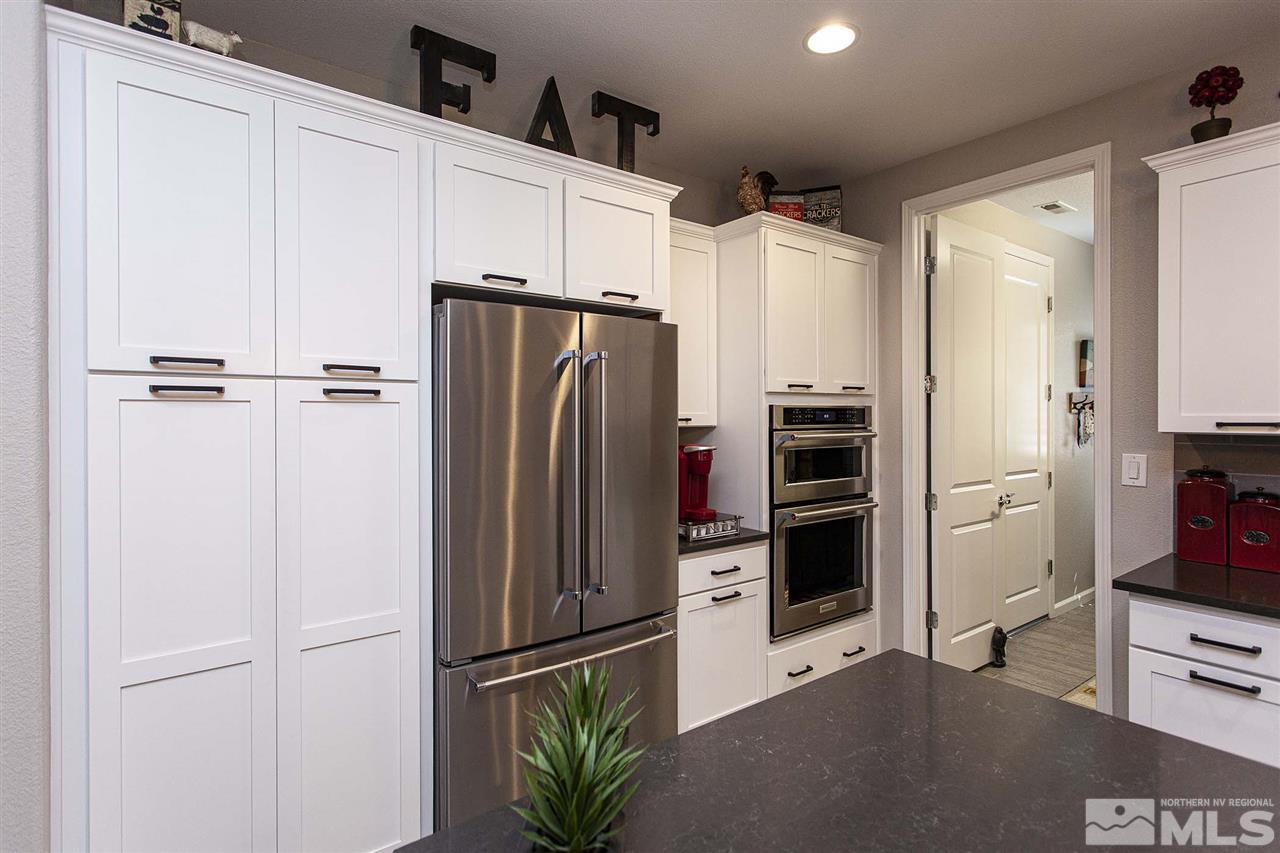 2190 Arpagos Lane Reno, NV 89521 - Photo 10 of 38 a kitchen with stainless steel appliances a refrigerator and cabinets