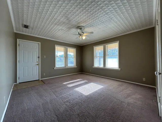 an empty room with windows and closet