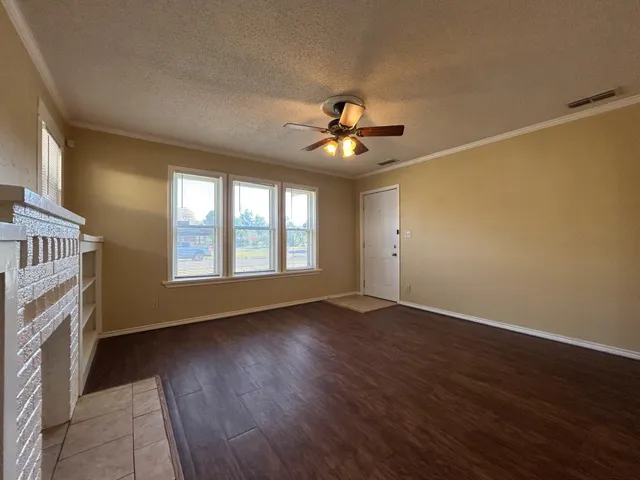 a view of an empty room with windows