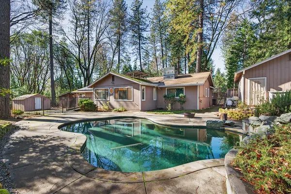 a view of house with backyard outdoor seating and trees