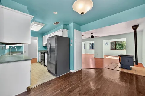 a kitchen with stainless steel appliances granite countertop a refrigerator and a stove top oven