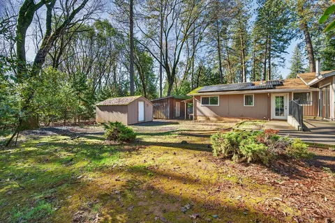 a front view of a house with a yard table and chairs