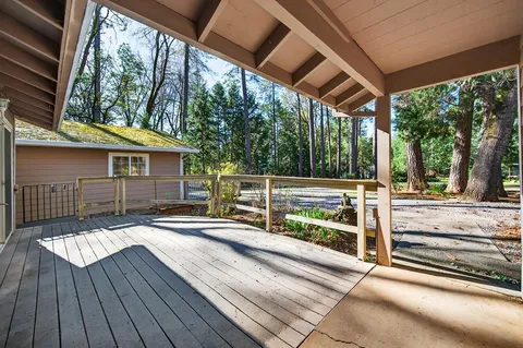 a view of house with wooden floor and outdoor seating