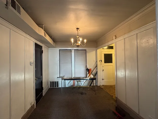 a view of a hallway with wooden shelves