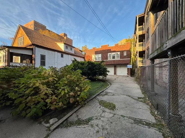 a view of multiple houses with a street
