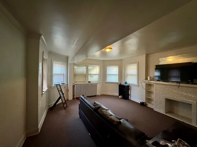 a living room with furniture fireplace and flat screen tv