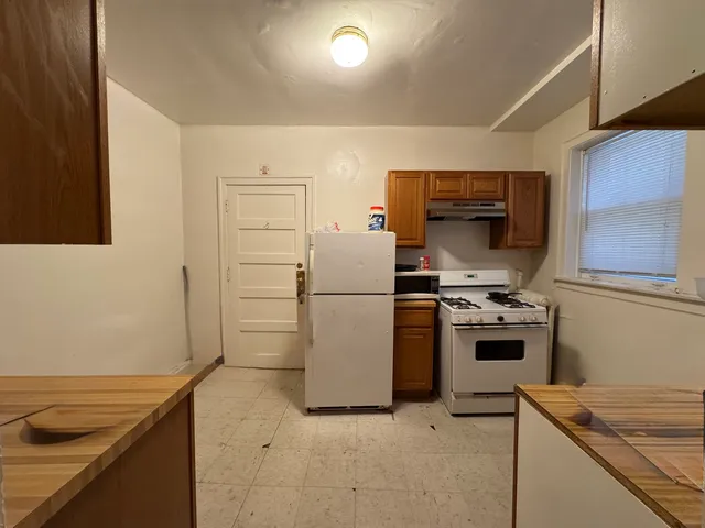 a kitchen with a sink a stove and refrigerator