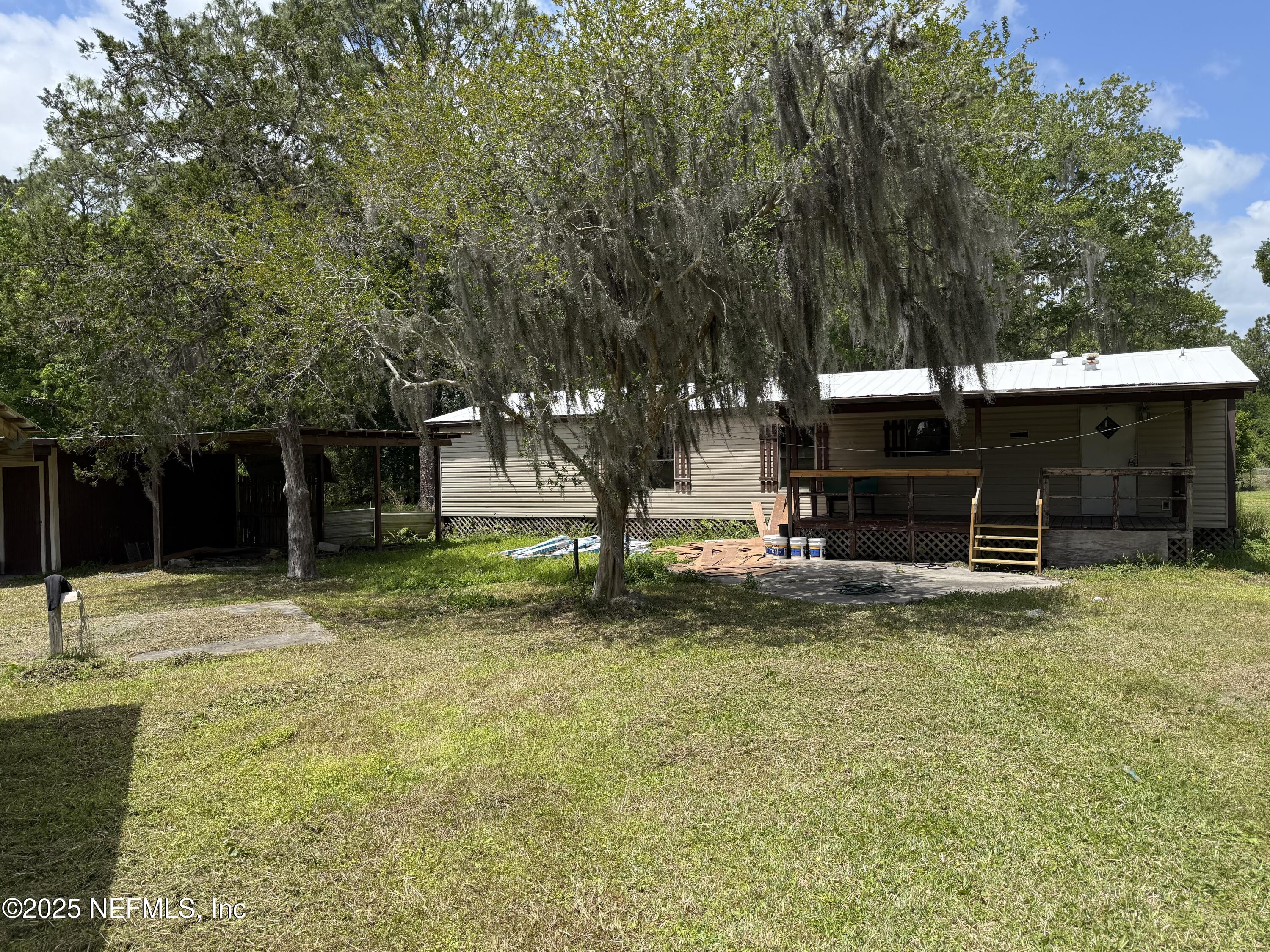 a view of a house with a backyard and a tree