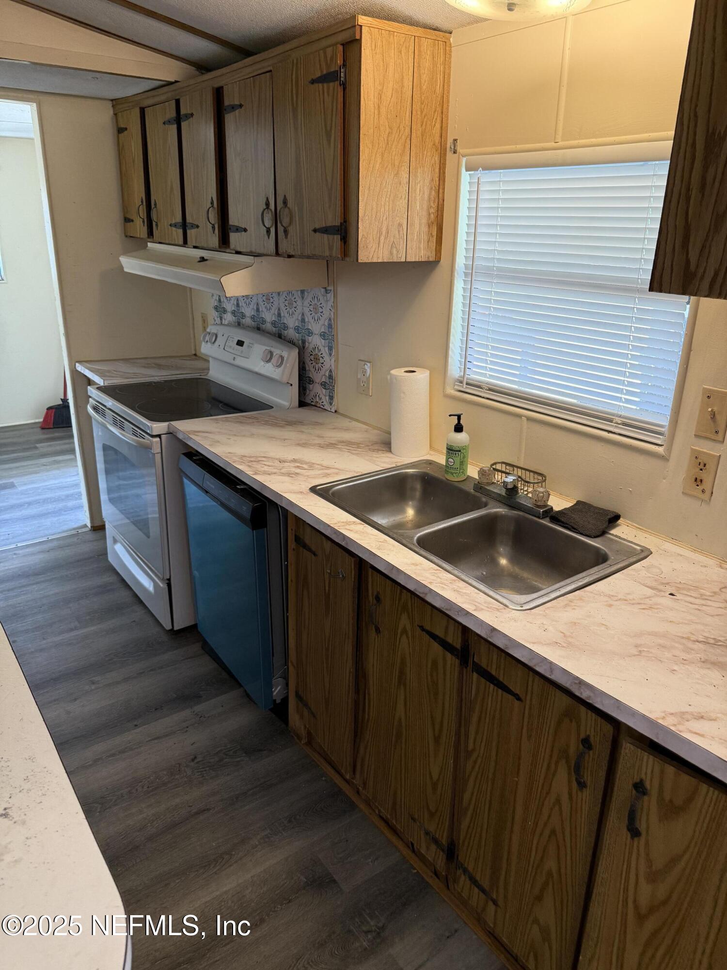 3255 County Road 208 St. Augustine, FL 32092 - Photo 12 of 22 a kitchen with stainless steel appliances granite countertop a sink stove and cabinets