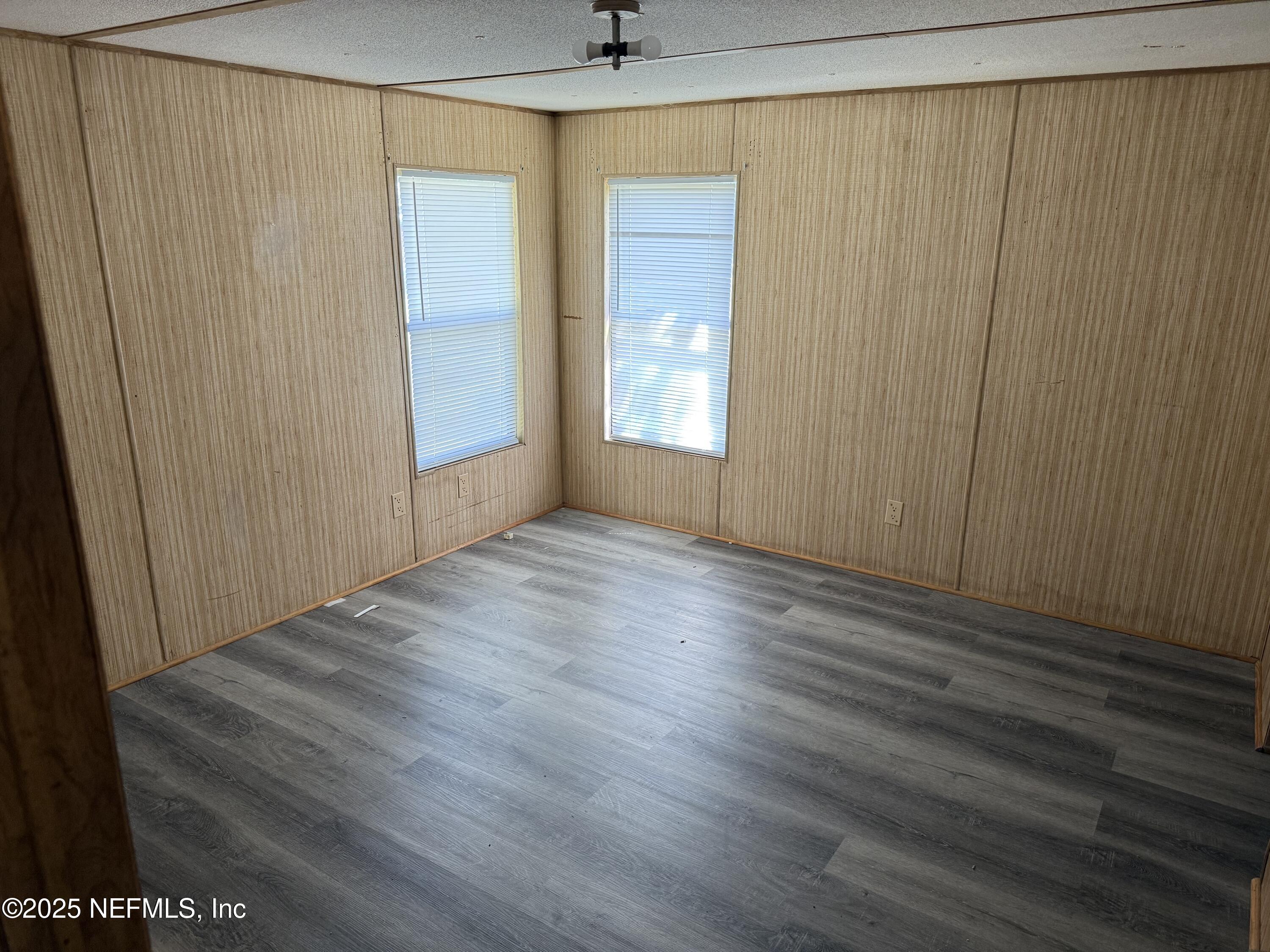 3255 County Road 208 St. Augustine, FL 32092 - Photo 16 of 22 a view of an empty room with wooden floor and a window