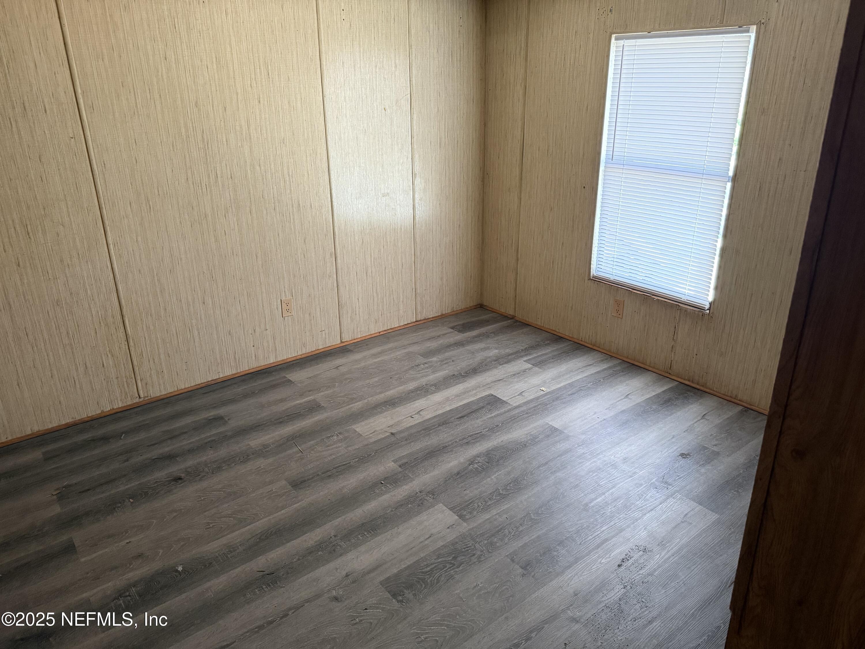 3255 County Road 208 St. Augustine, FL 32092 - Photo 17 of 22 a view of an empty room with wooden floor and a window