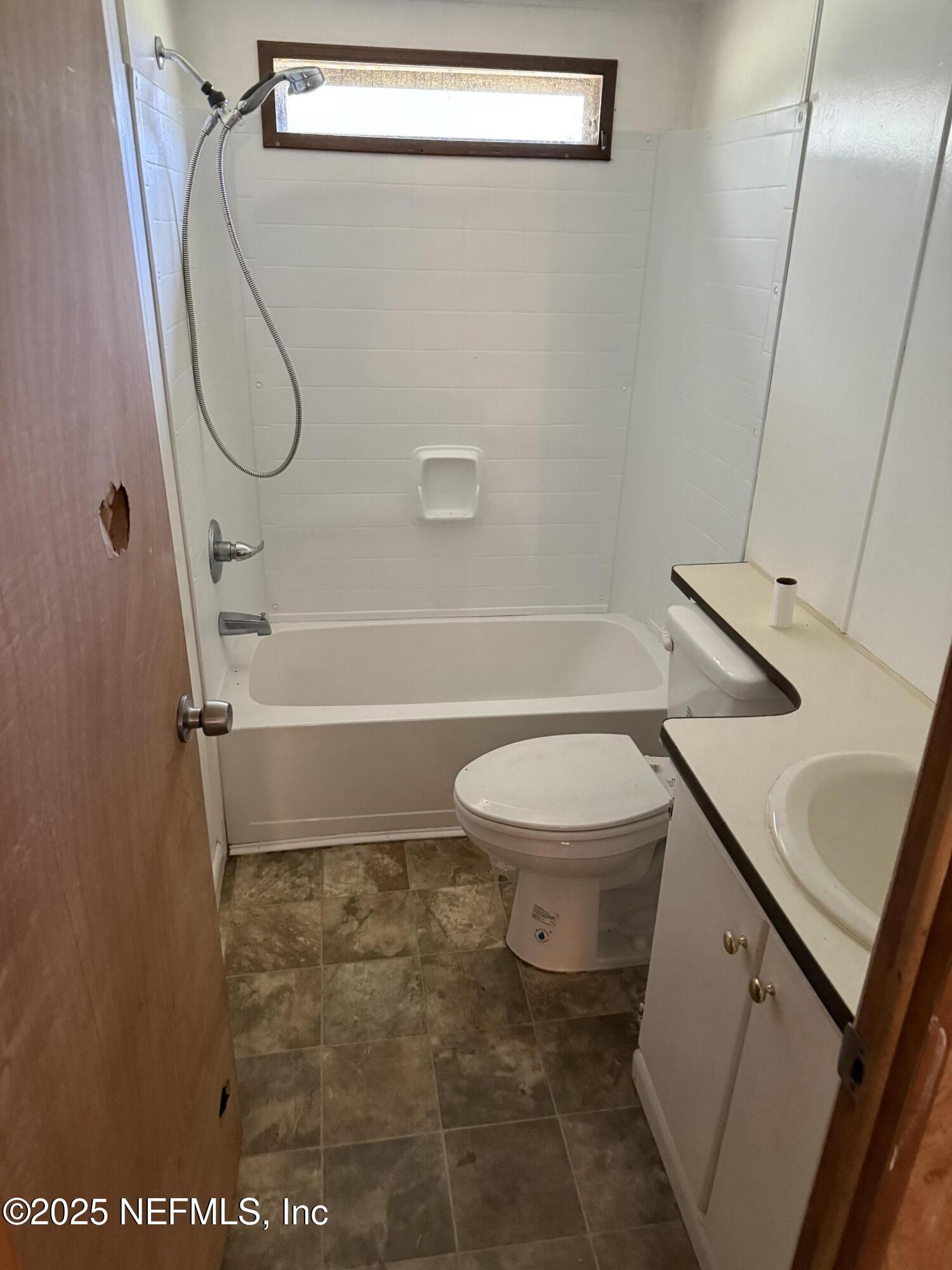 3255 County Road 208 St. Augustine, FL 32092 - Photo 18 of 22 a bathroom with a toilet sink and shower