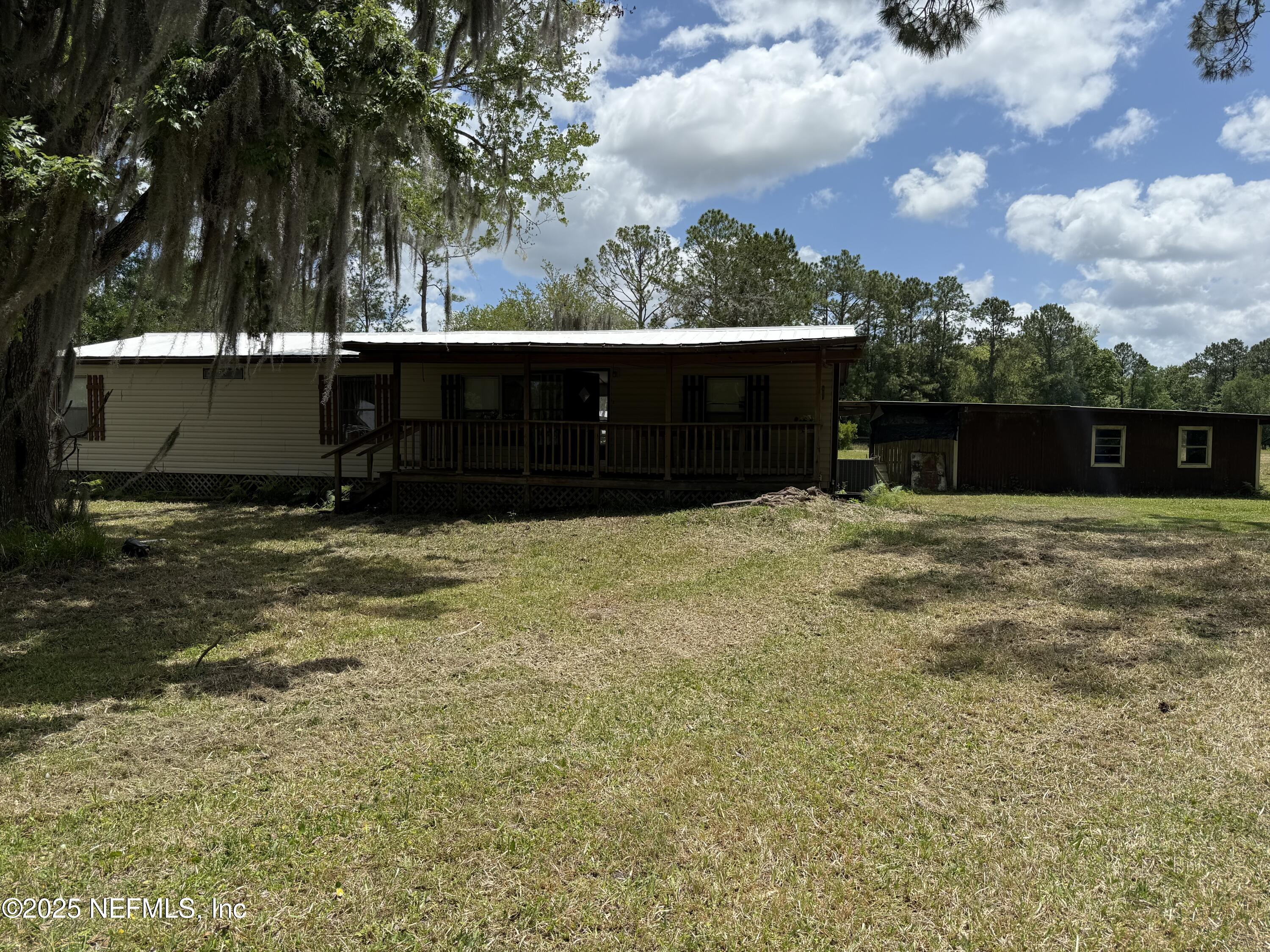 3255 County Road 208 St. Augustine, FL 32092 - Photo 2 of 22 a view of swimming pool with an outdoor seating and a yard