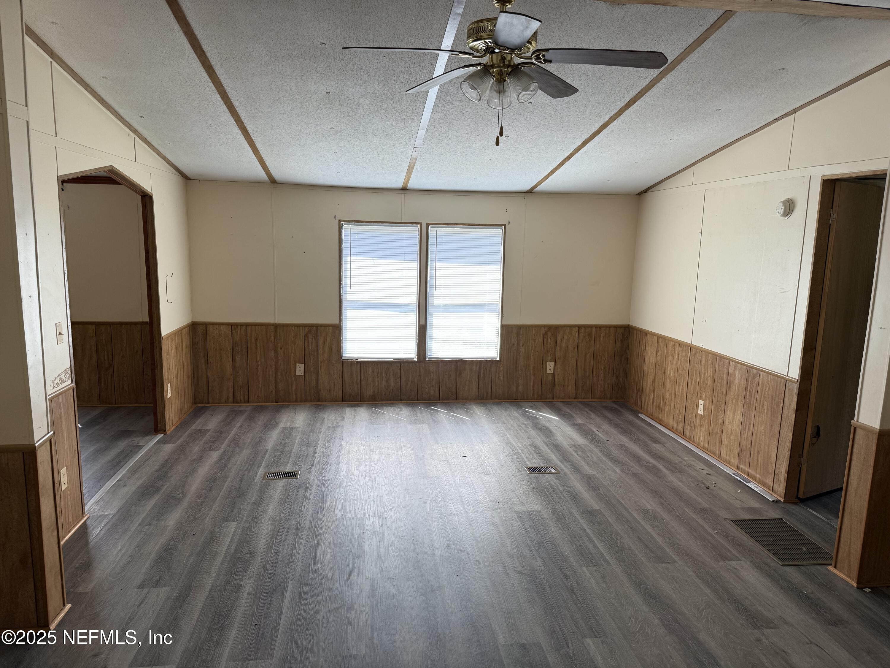 3255 County Road 208 St. Augustine, FL 32092 - Photo 6 of 22 wooden floor in an empty room with a window