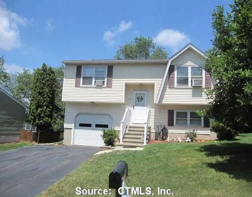 164 Meetinghouse Ridge Meriden, CT 06450 - Photo 1 of 1 a front view of a house with a yard and garage