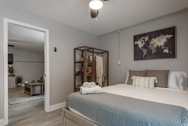 a bedroom with a bed and a painting on the wall