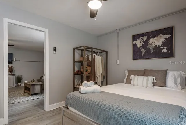 a bedroom with a bed and a painting on the wall