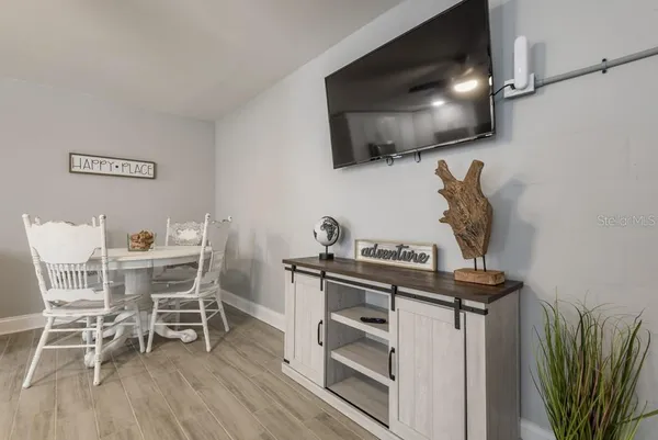 a view of a dining room with furniture and wooden floor