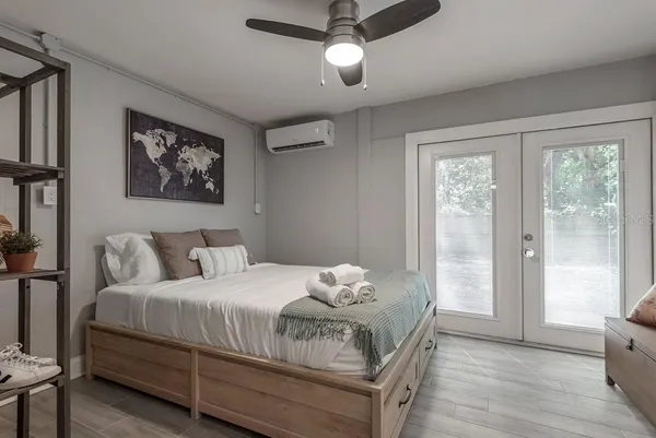 a bedroom with a large bed and a window