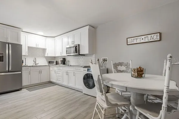 a kitchen with a sink cabinets and wooden floor