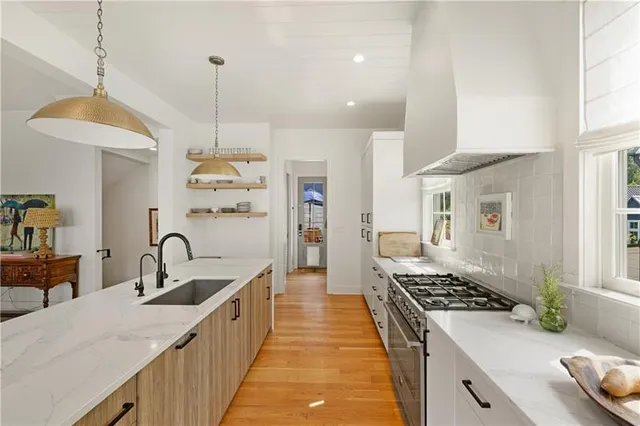 a kitchen with sink stove and refrigerator