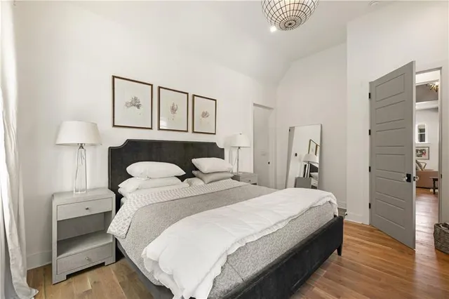 a bedroom with a bed and a night stand